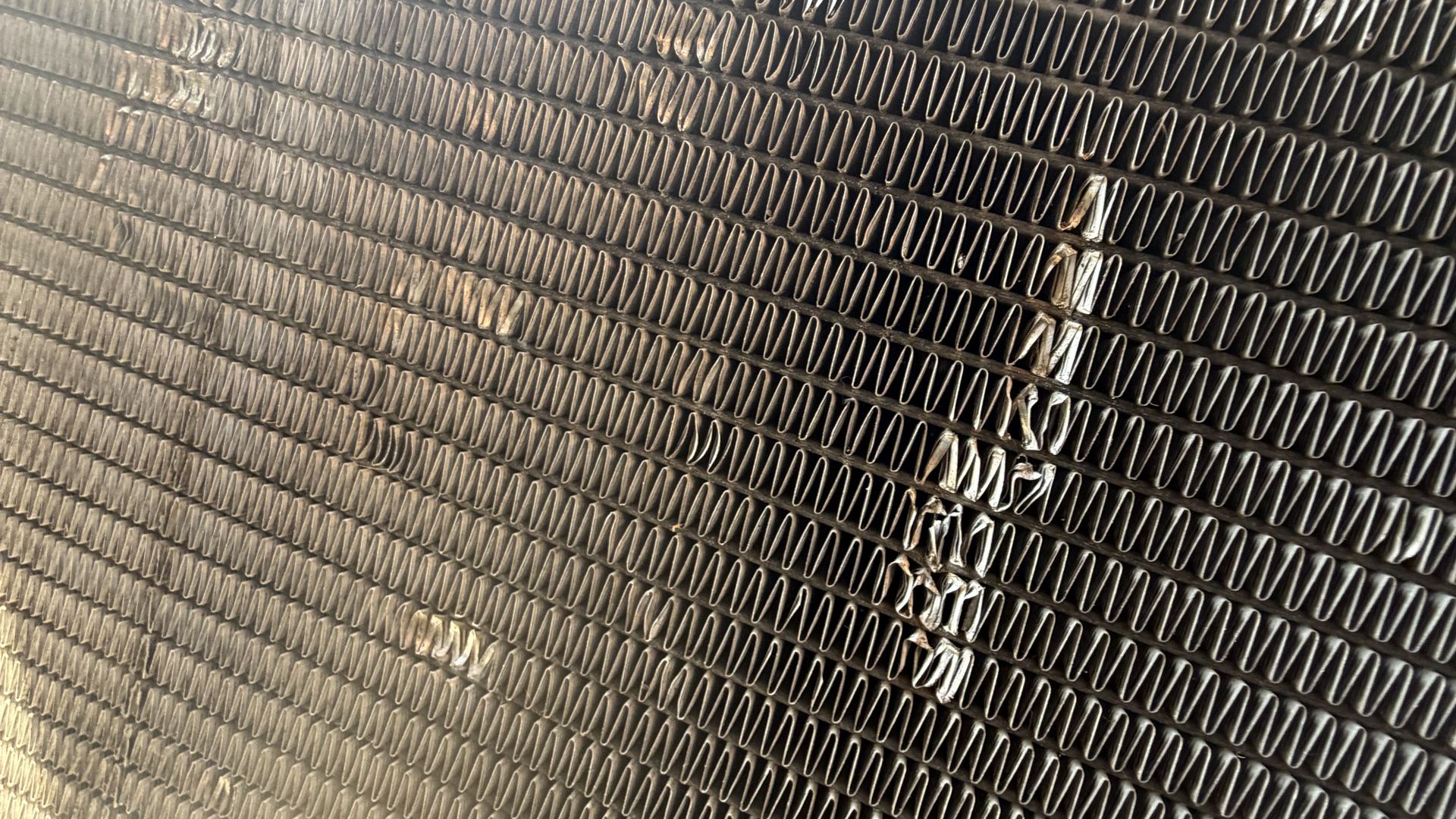 Radiator core with a section of damaged cooling fins