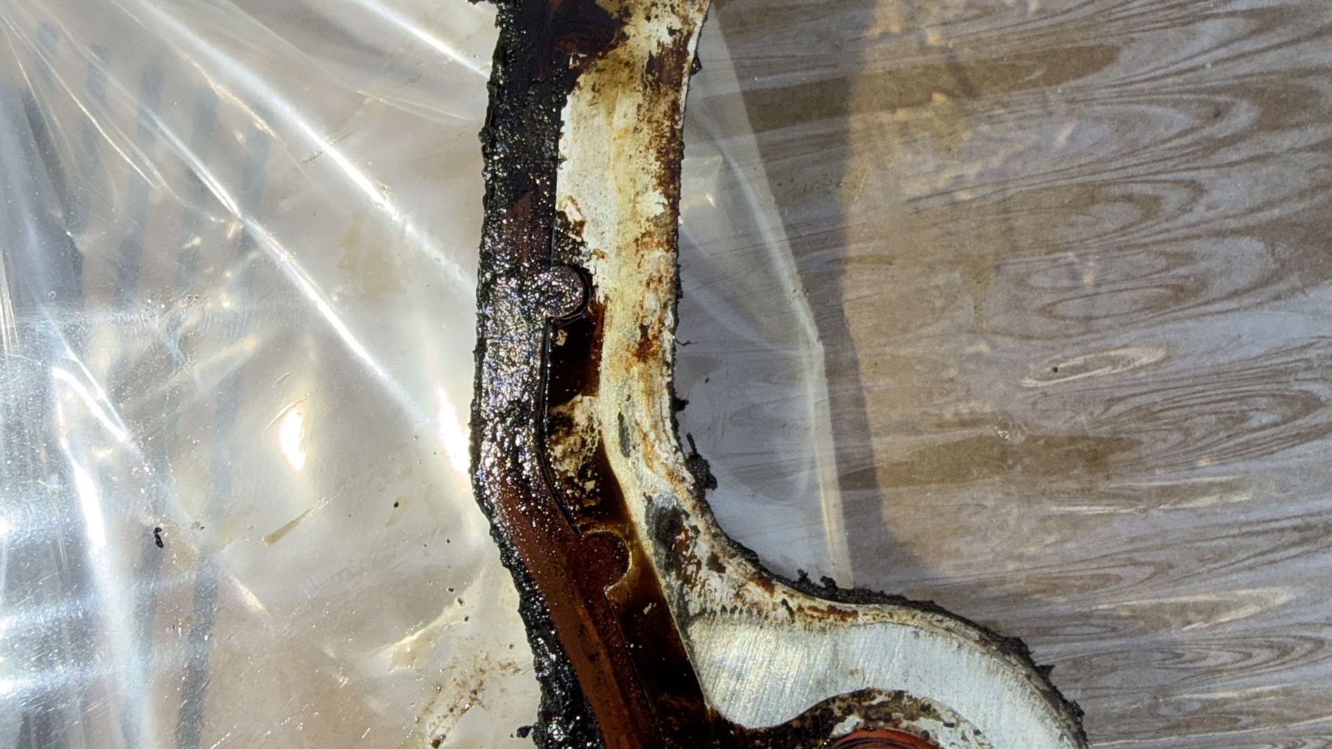 Worn timing cover gasket with old sealant