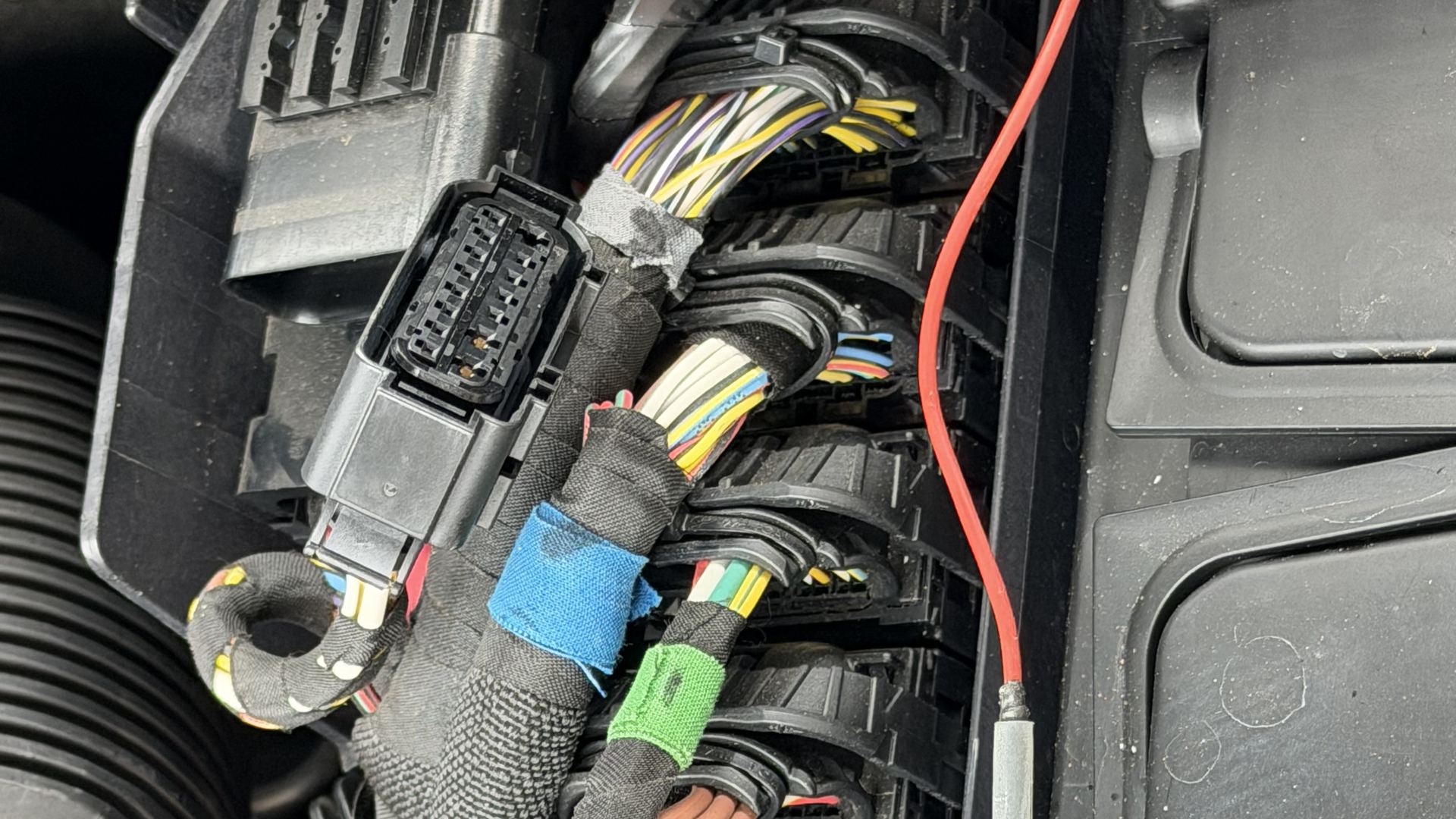 Engine wiring harness and connectors beside the intake