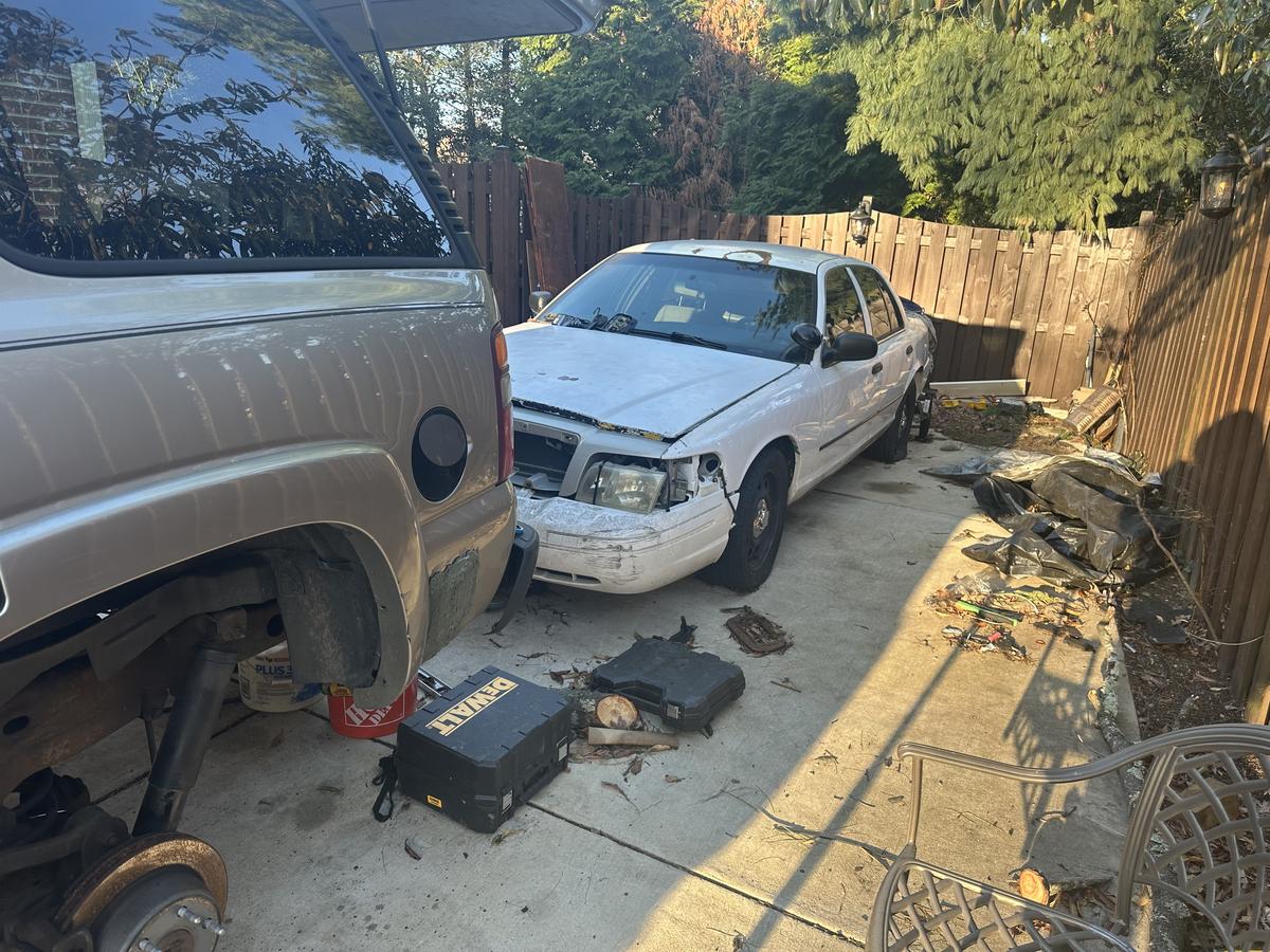 My Halo Auto mobile workspace with Ford Crown Victoria and tools on the ground