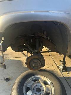 Chevrolet wheel well with the wheel removed and the hub and brake exposed