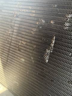 Radiator core with a section of damaged, bent cooling fins