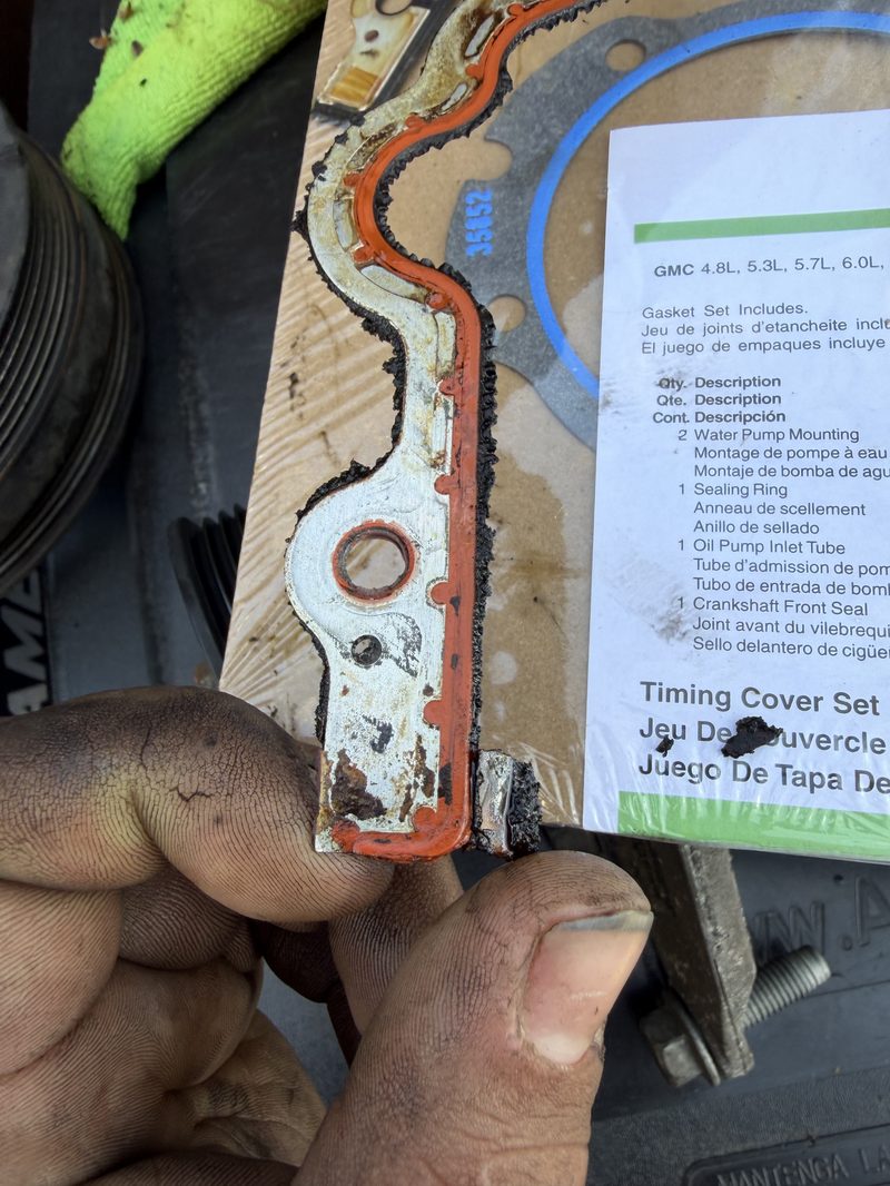 Old vs new timing cover gasket comparison showing wear and degradation