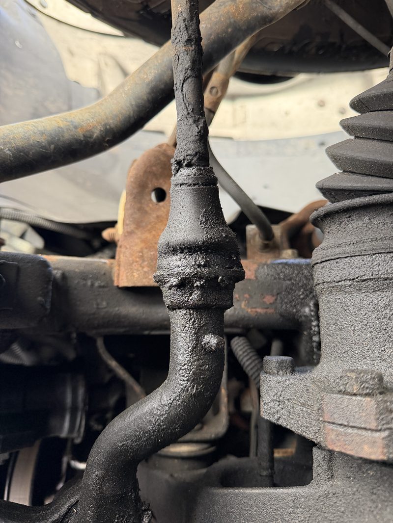 Undercarriage view showing control arm and brake caliper during service