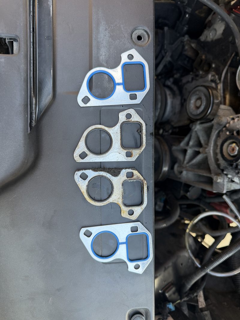 New vs old water pump gaskets side by side showing corrosion and failure